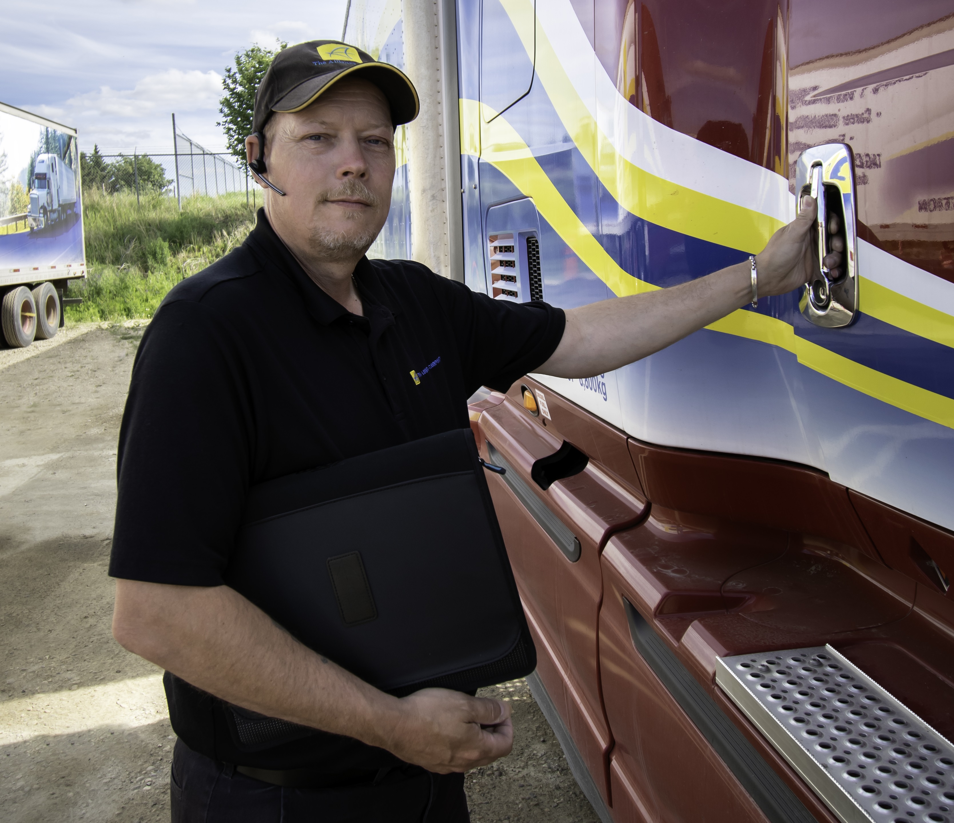 male leaning on the side of a white semi-truck