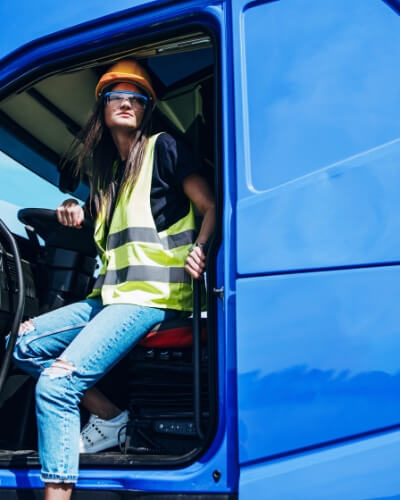 A woman stepping out of a blue truck