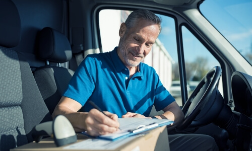 A truck driver taking notes