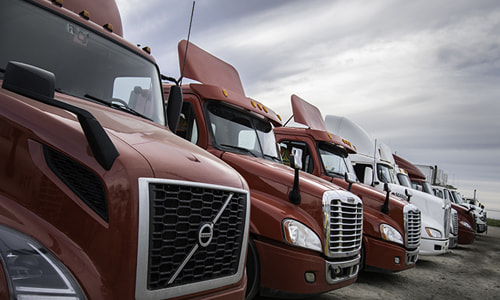 a row of red and white semi-trucks