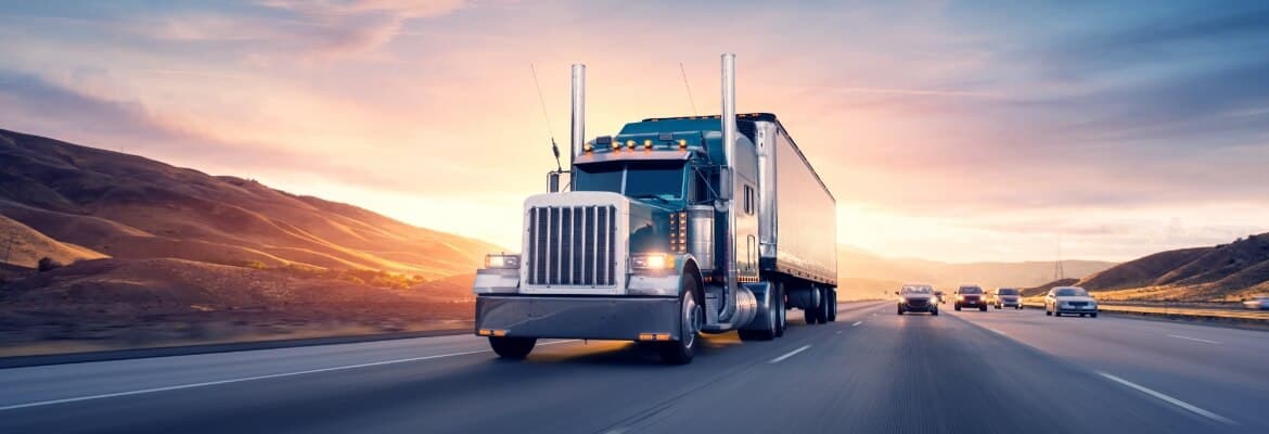 a semi-truck driving down a highway