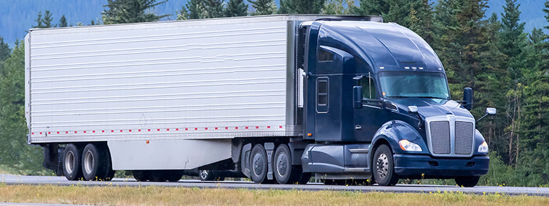 blue semi-truck on the road