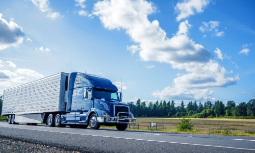 blue semi-truck on the road