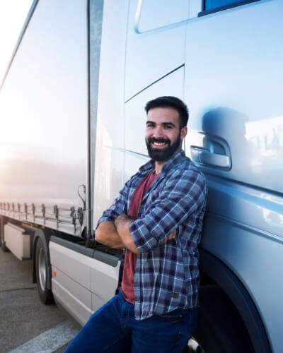 male leaning on the side of a white semi-truck