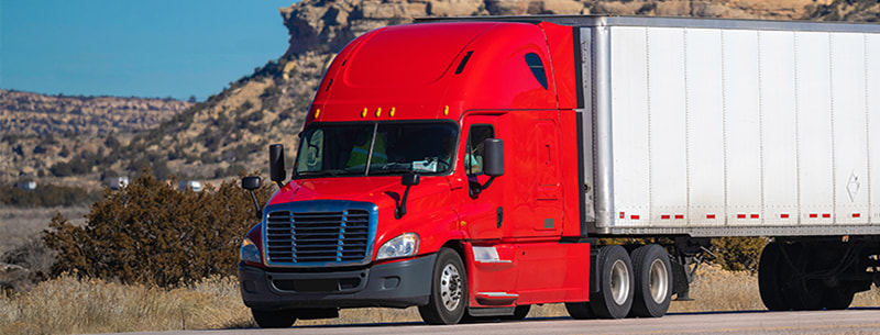 red semi-truck on the road