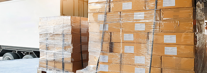 two pallets of stack boxes and a white trailer